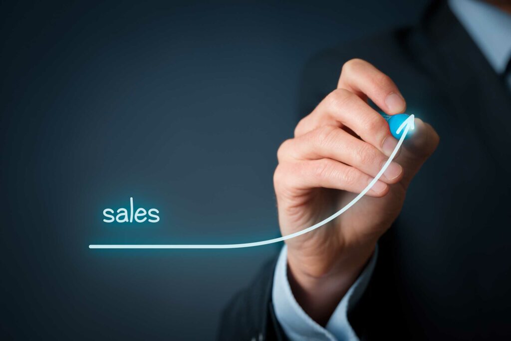 hand drawing a graph showing an increase in sales